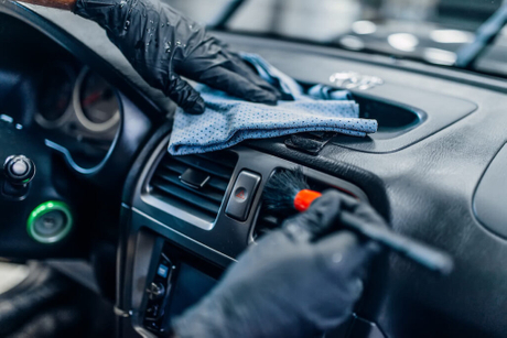 car-detailer-cleaning-the-interior-of-a-car.jpeg